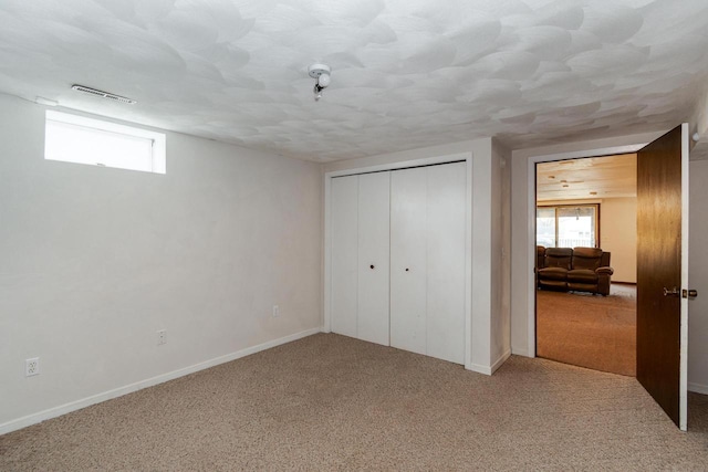 unfurnished bedroom with a closet and carpet flooring