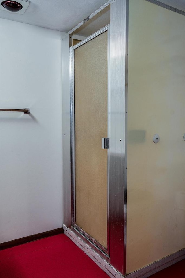 bathroom featuring a shower with shower door