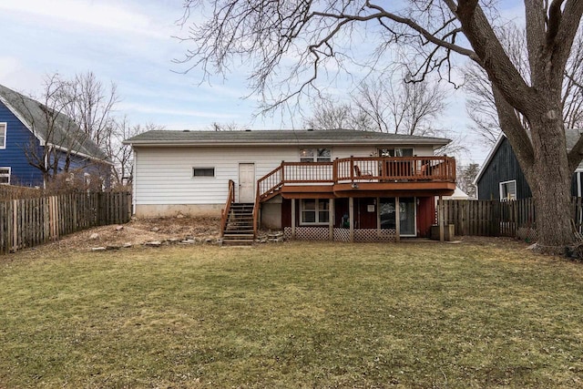 back of house featuring a wooden deck and a lawn