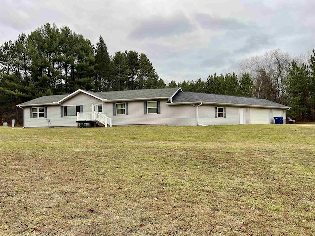 view of front of property with a garage and a front lawn