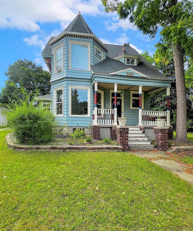 victorian-style house with covered porch and a front lawn