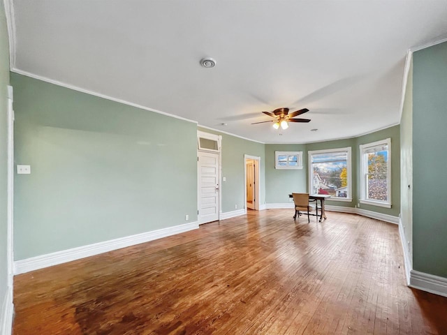 empty room featuring hardwood / wood-style floors, ceiling fan, and crown molding