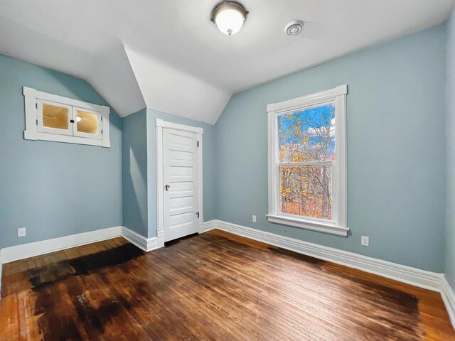 bonus room featuring dark hardwood / wood-style floors and vaulted ceiling