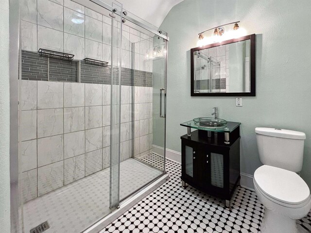 bathroom with tile patterned flooring, vanity, toilet, and walk in shower