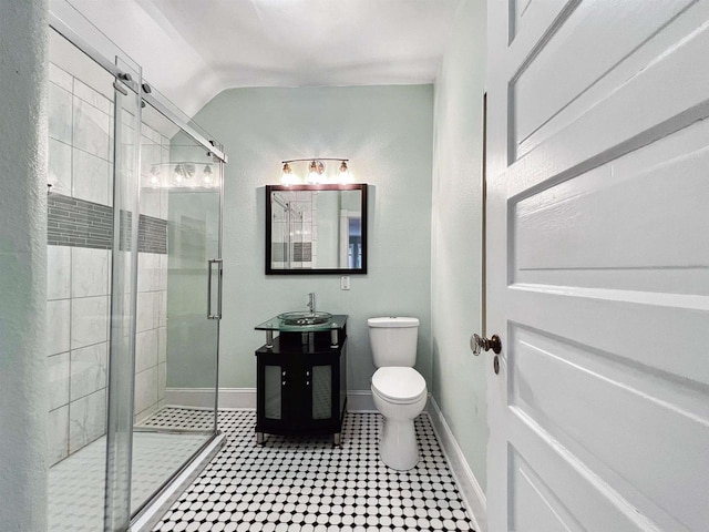 bathroom featuring toilet, an enclosed shower, and lofted ceiling