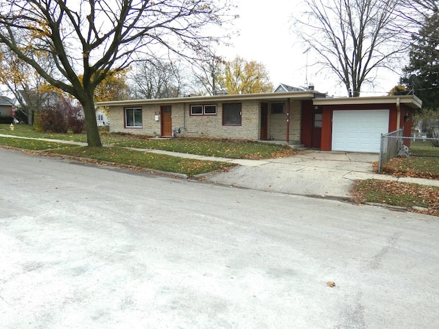 single story home featuring a garage and a front lawn