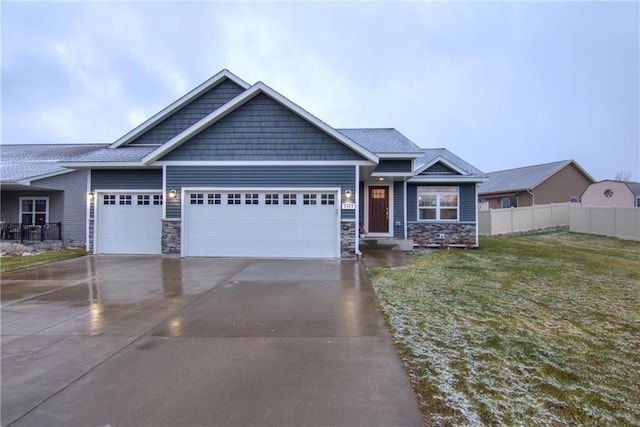 craftsman-style house featuring a garage and a front lawn