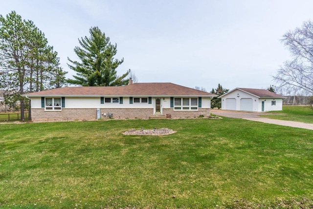 ranch-style house featuring a front lawn, an outdoor structure, and a garage