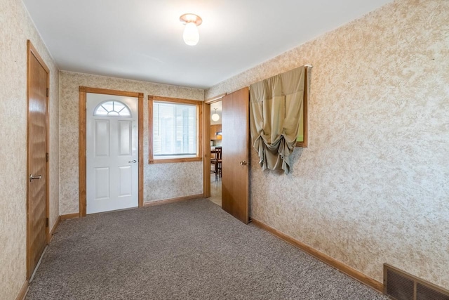 view of carpeted foyer entrance