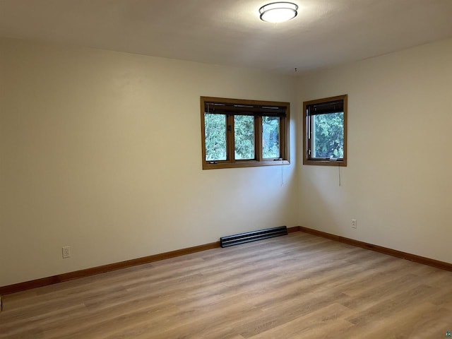 spare room featuring light wood-type flooring