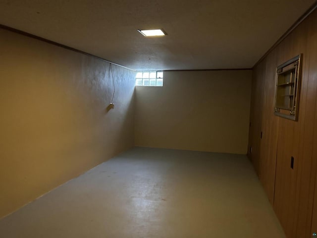 basement featuring wooden walls