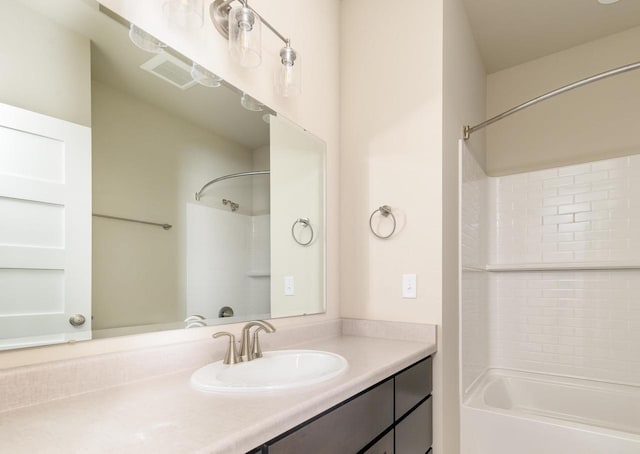 bathroom featuring visible vents, vanity, and shower / bathtub combination