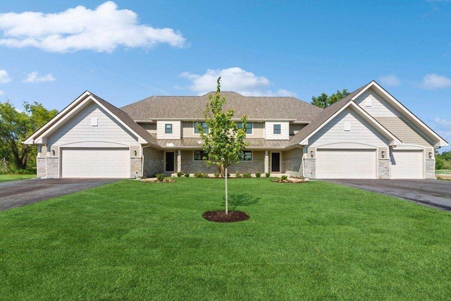649 Eagleton Dr Unit 55-14, Lake Geneva, WI 53147 - view of front of house featuring driveway, stone siding, an attached garage, a front yard, and a standing seam roof