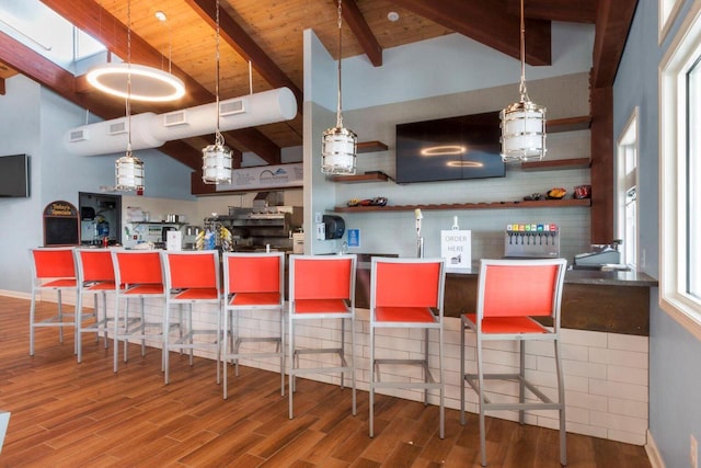 kitchen featuring wood ceiling, beam ceiling, pendant lighting, hardwood / wood-style flooring, and high vaulted ceiling