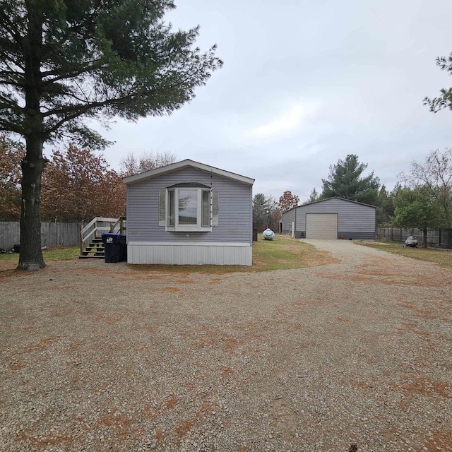 view of home's exterior featuring a garage and an outbuilding