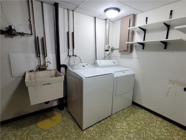 clothes washing area featuring washing machine and clothes dryer and sink