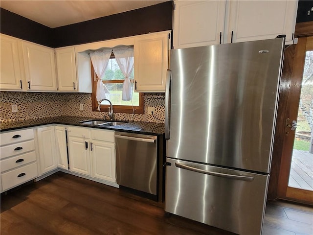 kitchen with white cabinets, backsplash, stainless steel appliances, and sink