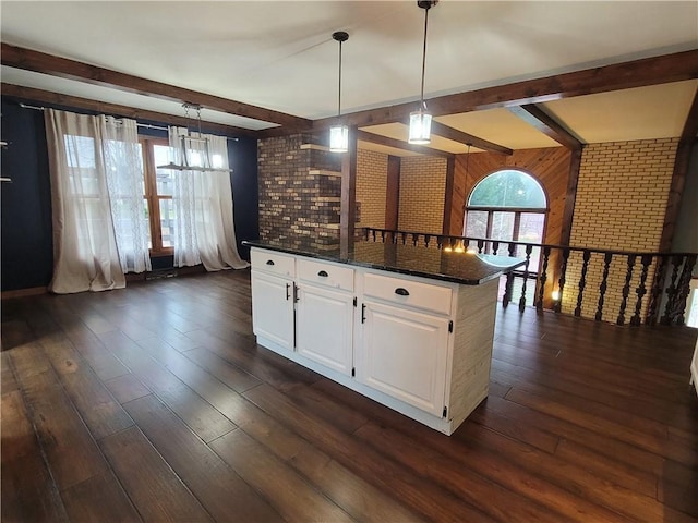 kitchen with white cabinets, dark hardwood / wood-style flooring, decorative light fixtures, and dark stone countertops