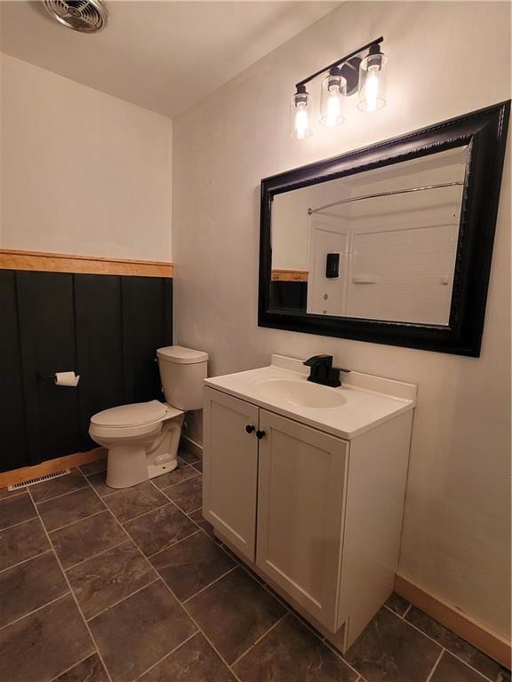 bathroom with vanity and toilet