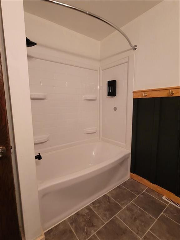 bathroom with tile patterned floors and shower / bathtub combination