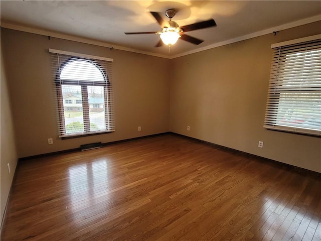 empty room with hardwood / wood-style flooring, ceiling fan, and ornamental molding