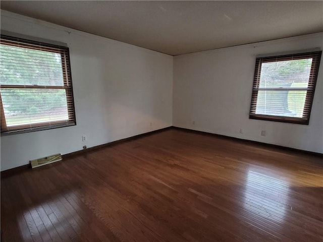 unfurnished room featuring dark hardwood / wood-style flooring