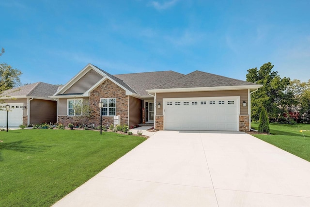 5240 Briarwood Cir, Racine, WI 53402 - view of front facade with an attached garage, a front lawn, driveway, and stone siding