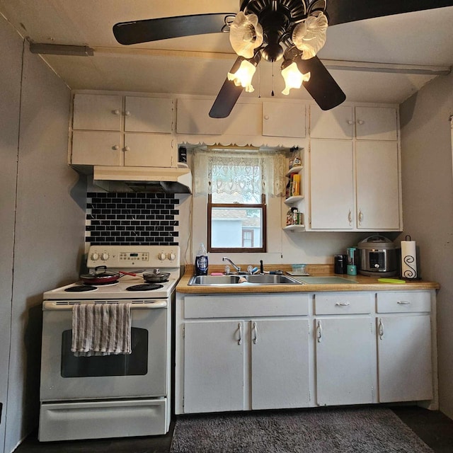 kitchen with electric range, white cabinetry, ceiling fan, and sink