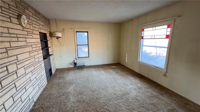 unfurnished living room featuring carpet and a textured ceiling