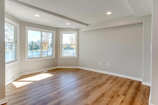 spare room featuring light hardwood / wood-style floors