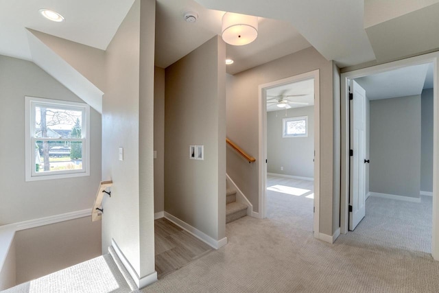 hallway with light colored carpet