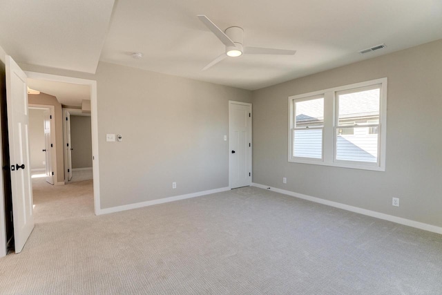 carpeted spare room featuring ceiling fan