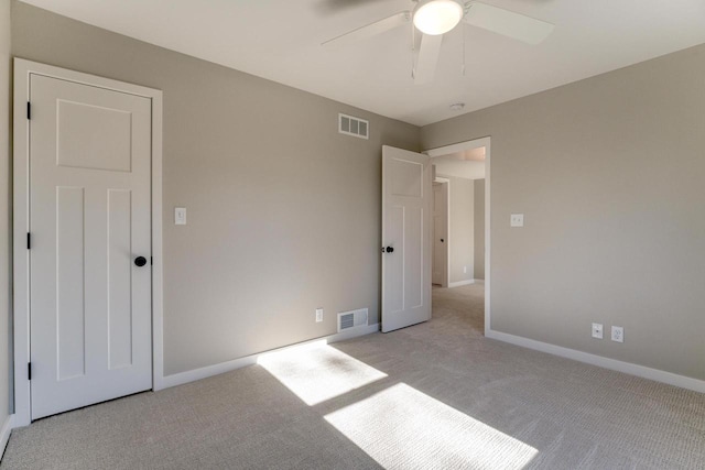 unfurnished bedroom featuring ceiling fan and light colored carpet