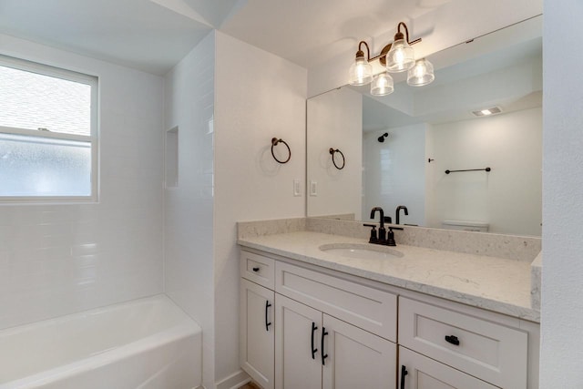 bathroom with vanity and tiled shower / bath combo