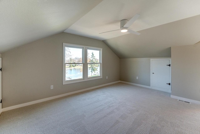 additional living space featuring light carpet, ceiling fan, and lofted ceiling