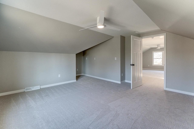 additional living space featuring carpet floors, ceiling fan, and lofted ceiling