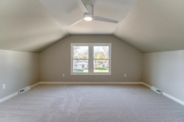 additional living space with ceiling fan, light colored carpet, and lofted ceiling