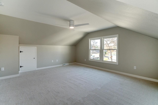 bonus room featuring ceiling fan, light colored carpet, and vaulted ceiling