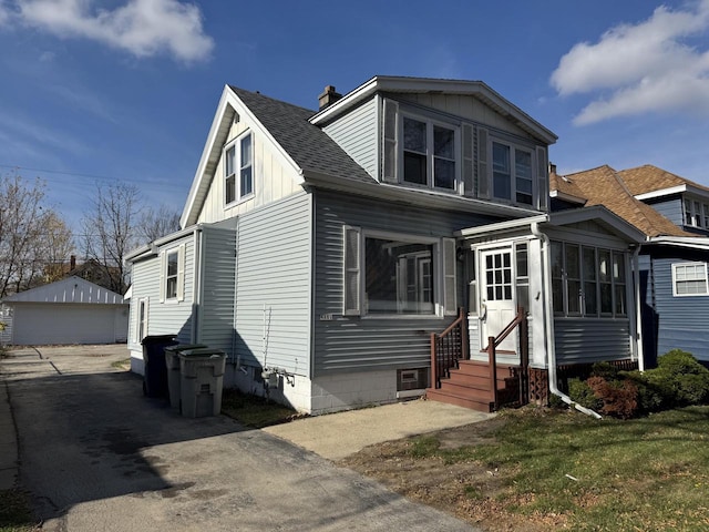 view of front of property featuring a garage and an outbuilding