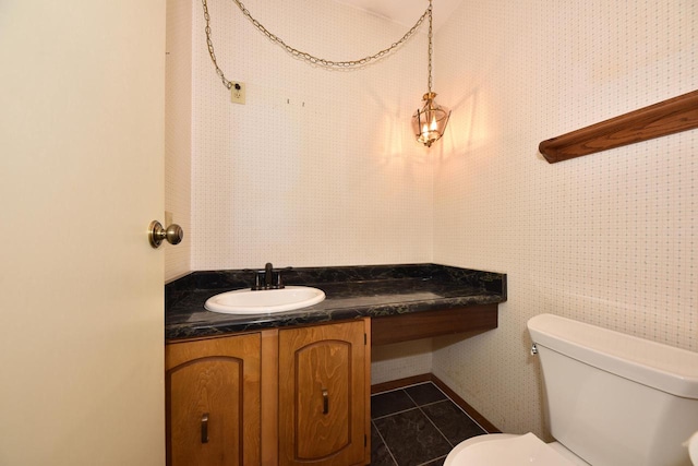 bathroom featuring tile patterned floors, vanity, and toilet