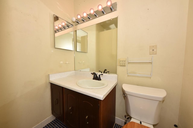 bathroom featuring tile patterned floors, vanity, and toilet