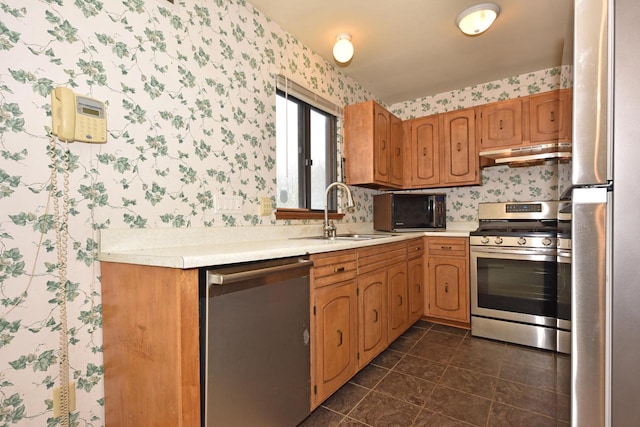 kitchen featuring sink, dark tile patterned flooring, and appliances with stainless steel finishes