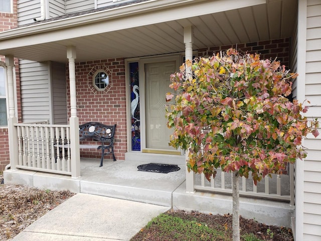 view of exterior entry featuring a porch