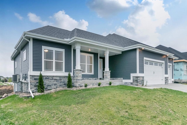 view of front facade featuring covered porch, central AC, a garage, and a front yard