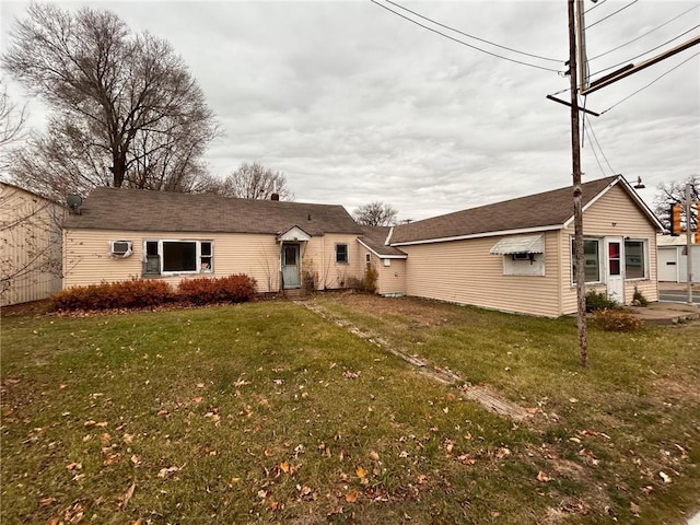 rear view of property with a yard