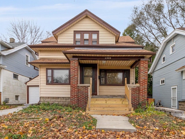 bungalow-style home with a porch and a garage