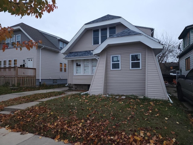 bungalow-style house featuring a front yard