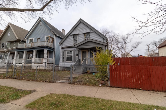 view of front facade with a balcony and covered porch