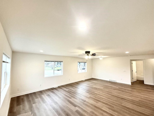 spare room featuring dark hardwood / wood-style floors and ceiling fan