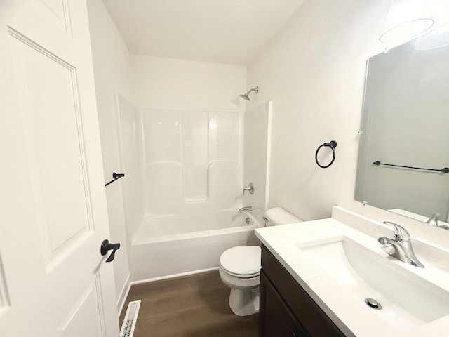 full bathroom featuring vanity, wood-type flooring, bathtub / shower combination, and toilet